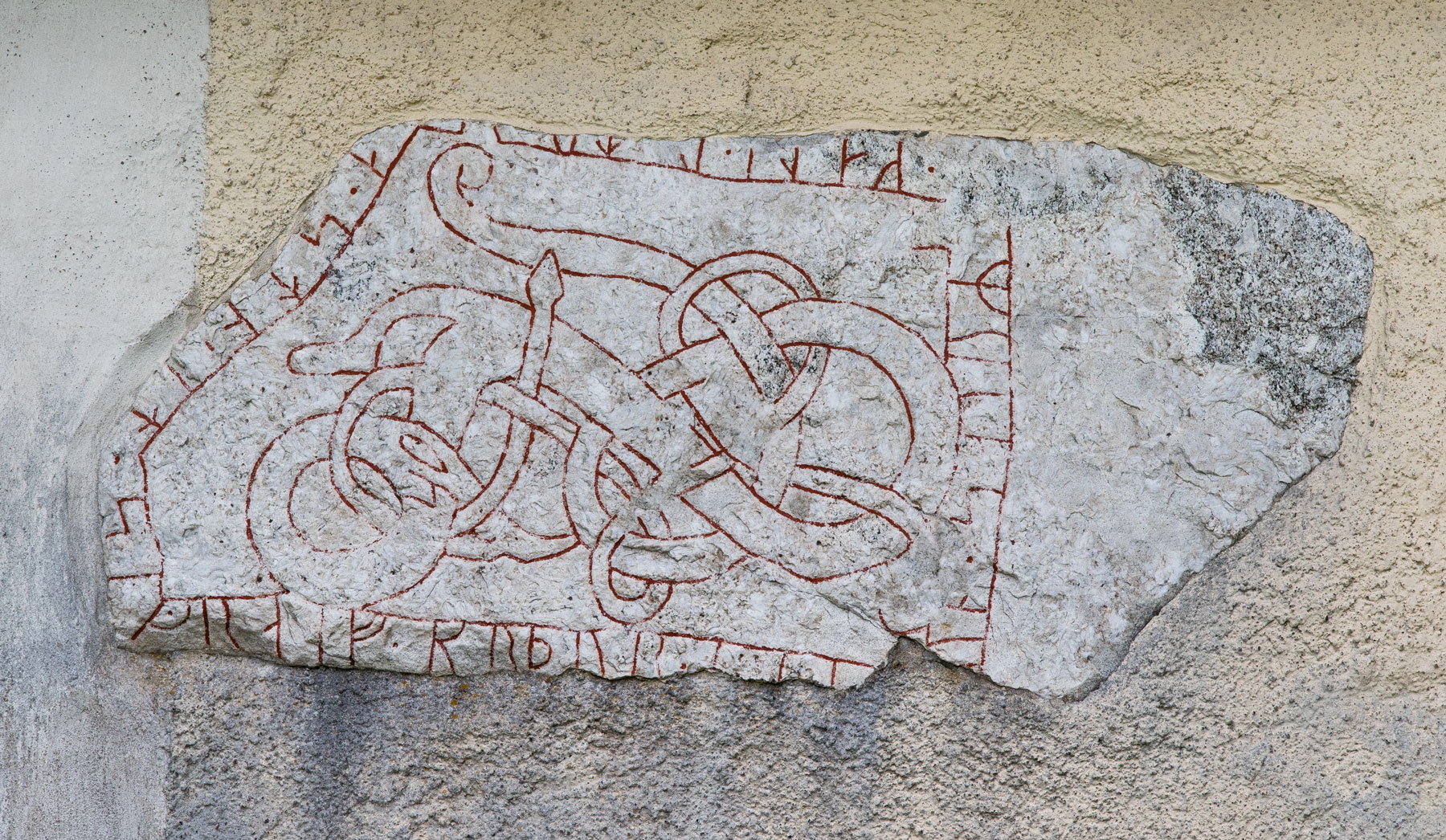Fragment av runsten i kyrkmuren - Kungs-Husby kyrka